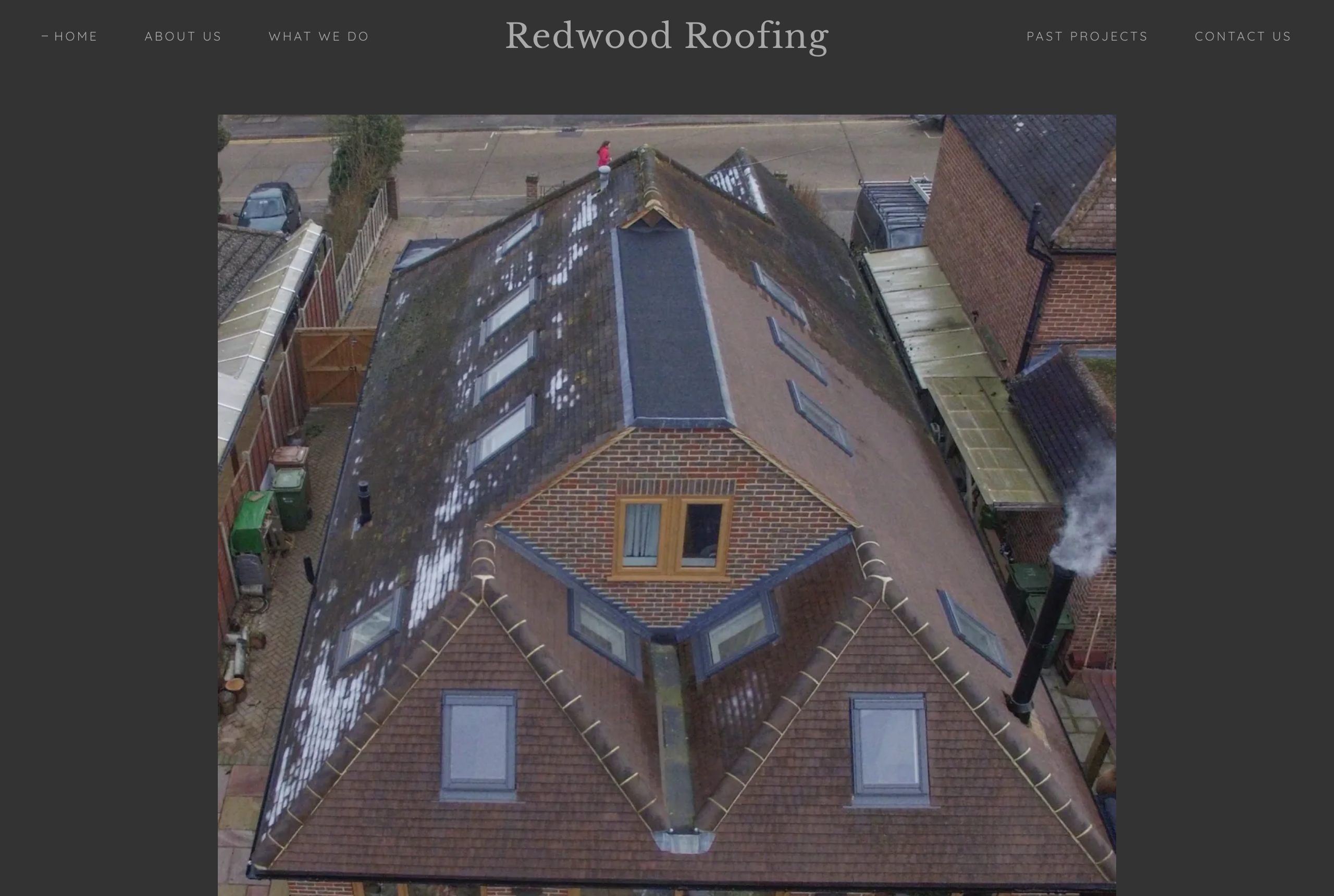 A dated roofing website, blurred to protect the business